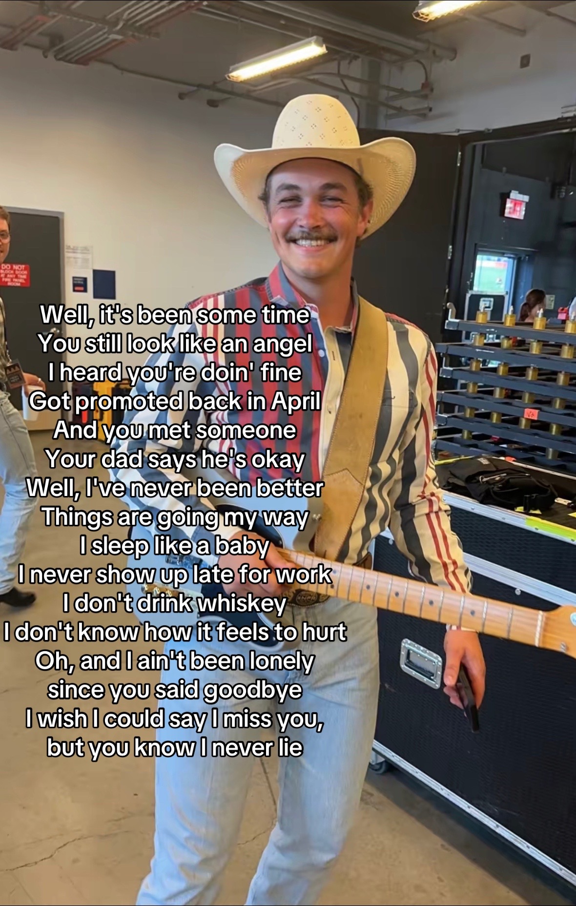 Slide 5 of 5: Zach Top with guitar + I Never Lie lyric overlay · @zachtopsjeans · Photo Mode · I Never Lie · ~975.9K plays (Apify 2026-10-07)